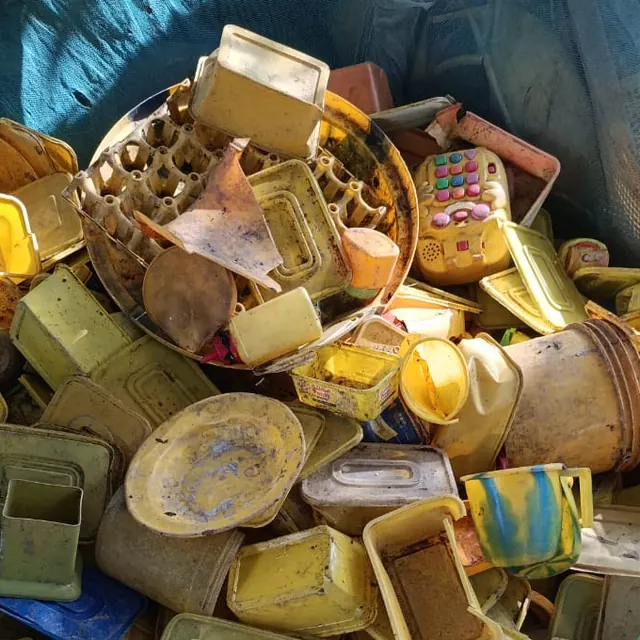 Pile of sorted yellow plastic containers and lids